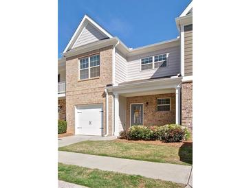 Charming townhome with brick facade, garage, and welcoming front porch at 234 Madison Ave, Acworth, GA 30102