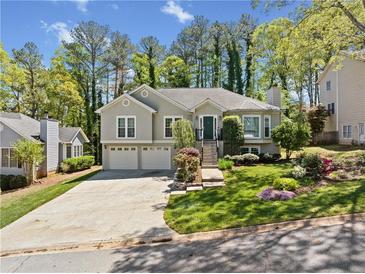 Charming home with a two-car garage, landscaped front yard, and inviting front entrance at 434 Meadowfield Ct, Lawrenceville, GA 30043