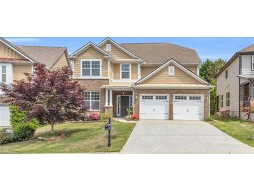 Charming two-story home with brick accents, a well-manicured lawn, and a two-car garage at 5480 Beaver Ridge Drive Dr, Cumming, GA 30040