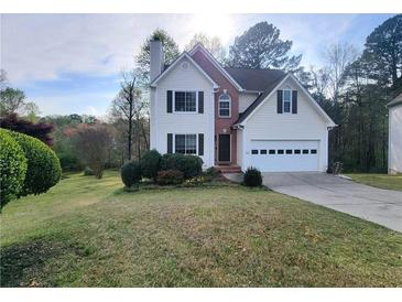 Charming two-story home with attached garage and well-manicured front lawn at 1535 Wilkes Crest Dr, Dacula, GA 30019