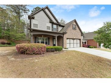Charming two-story home featuring a brick and gray siding exterior, with a well-manicured lawn at 2172 Misty Brook Ct, Buford, GA 30519