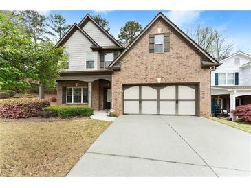 Charming two-story brick home with a well-manicured lawn and inviting two-car garage at 2172 Misty Brook Ct, Buford, GA 30519