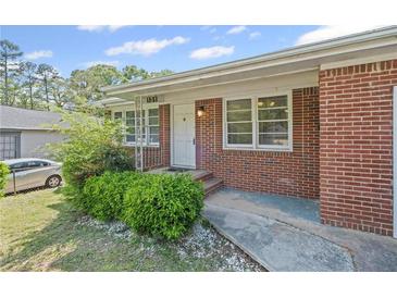 Charming brick home with a well-maintained lawn and inviting entrance, showcasing classic curb appeal at 131 Brownlee Rd, Atlanta, GA 30331