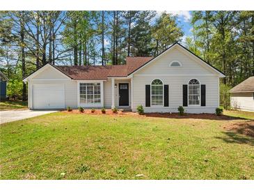 Charming single-story home features a well-manicured front yard and attached garage at 10331 Wrens Dr, Jonesboro, GA 30238