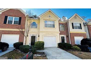 Charming townhome featuring well-maintained landscaping, a two-car garage, and welcoming front entrances at 4134 Rogers Creek Ct # 41, Duluth, GA 30096