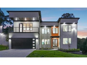 Modern two-story home with a two-car garage, balcony, and manicured lawn at 1610 Niskey Lake Sw Rd, Atlanta, GA 30331