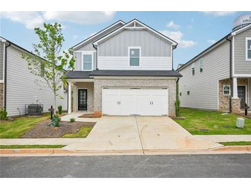 Charming two-story home boasts a two-car garage and manicured lawn at 2770 Aralynn Way, College Park, GA 30337