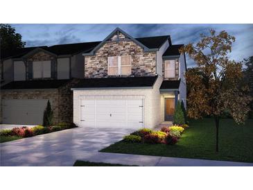 Charming two-story home with stone and white brick and a well-manicured lawn at 314 White Tail Rd, Stockbridge, GA 30253
