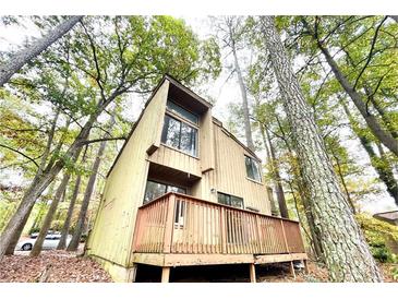 Stylish two-story home featuring a wooden deck and natural surroundings at 5806 Par Four Ct, Lithonia, GA 30038
