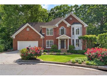 Charming two-story red brick home with manicured lawn and mature trees at 1835 Berkeley Ne Mews, Atlanta, GA 30329