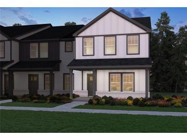 Charming two-story home with a covered porch, well-manicured lawn and eye-catching black and white color scheme at 2264 Ashton Dr, Conyers, GA 30013