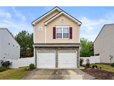 Charming home with a two-car garage, stone accents, and neutral siding on a bright day at 112 Silver Fox Trl, Dallas, GA 30157