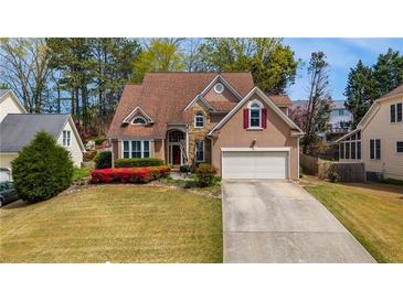 Charming two-story home with a well-maintained lawn and beautiful flowering bushes at 3270 River Summit Trl, Duluth, GA 30097