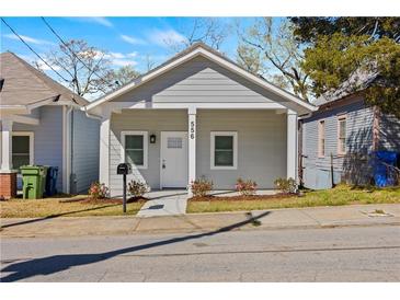 Charming bungalow with a fresh coat of gray paint, complemented by a crisp white door and trim, nestled in a friendly neighborhood at 556 James P Brawley Nw Dr, Atlanta, GA 30318