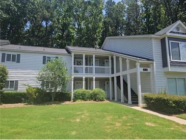 Inviting condominium complex featuring covered porches, landscaped grounds, and classic architectural details at 35 Rumson Se Ct, Smyrna, GA 30080
