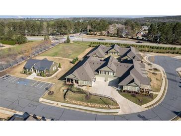 A beautiful aerial view of a residential neighborhood and surrounding greenery showcases the property's prime location at 57 Cedarcrest Village Ln, Acworth, GA 30101