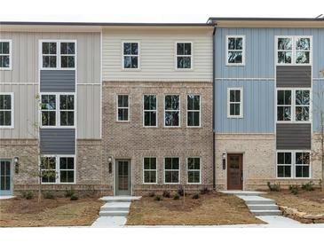 Charming exterior view of newly built townhomes with varied color schemes and brick accents at 1162 Buice Lake Pkwy, Acworth, GA 30102