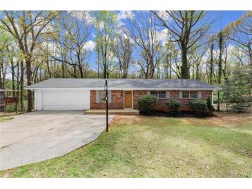 Charming single-story brick home featuring a well-maintained lawn and an attached two-car garage at 6175 Knights Ln, Douglasville, GA 30135
