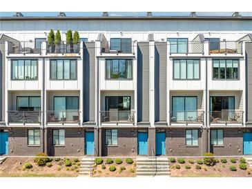 Modern townhome exterior featuring balconies, brick accents, and vibrant blue doors at , Atlanta, GA 30315
