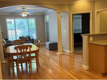 Open dining and living area featuring hardwood floors, large windows, and elegant architectural details at 1106 Stratford Commons, Decatur, GA 30033