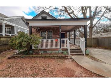 Charming home featuring a stone facade, covered front porch, and well-maintained landscaping at 1852 E Farris Ave, Atlanta, GA 30344