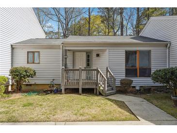 Charming single-story townhome featuring a wooden porch and well-maintained front lawn at 404 Willow Way, Villa Rica, GA 30180