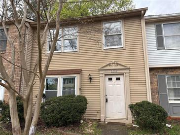 Charming townhouse featuring a light exterior, well-maintained landscaping, and a welcoming front entrance at 2834 Royal Path Ct, Decatur, GA 30030
