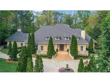 Stunning traditional two-story home featuring a symmetrical facade, manicured landscaping, and elegant entryway at 3835 Paces Ferry Nw Rd, Atlanta, GA 30327