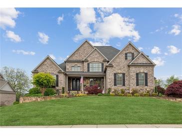 Impressive brick home with manicured lawn, beautiful landscaping, and a welcoming front porch at 968 Woodtrace Ln, Auburn, GA 30011