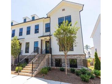 Beautiful townhouse with black trim, brick accents and professionally landscaped yard at 209 Phillips Ln, Alpharetta, GA 30009