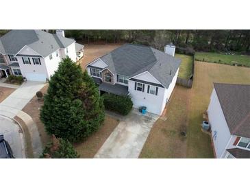 A beautiful two-story home in a suburban neighborhood featuring an attached two-car garage and driveway at 605 Oak Terrace Drive, Covington, GA 30016