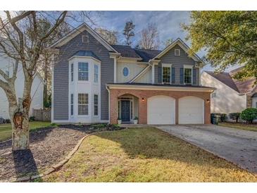 Charming two-story home with a well-manicured lawn and attached two-car garage at 4975 Skyland Pkwy, Cumming, GA 30028