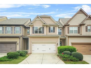 Charming two-story townhome with a well-manicured front yard and attached garage at 5669 Cobblestone Creek Pl # 12, Mableton, GA 30126