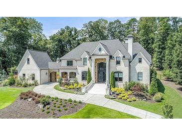 Stately brick home with manicured landscaping, circular driveway, and grand entrance, exuding curb appeal at 211 Meritage Dr, Alpharetta, GA 30022