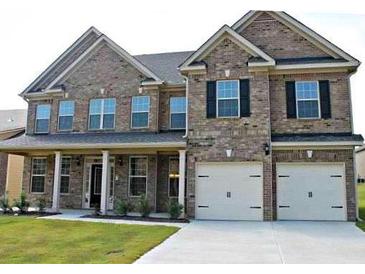 Beautiful brick two story home with a two car garage and a well manicured lawn at 80 Lanier Rdg, Acworth, GA 30101