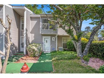 Charming townhome exterior featuring well-maintained landscaping and gray siding at 105 Governors Dr, Forest Park, GA 30297