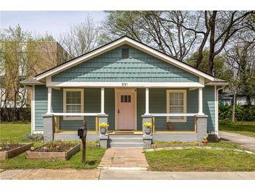 Charming bungalow featuring a covered front porch, craftsman details, and a well-maintained lawn at 891 Spencer Nw St, Atlanta, GA 30314