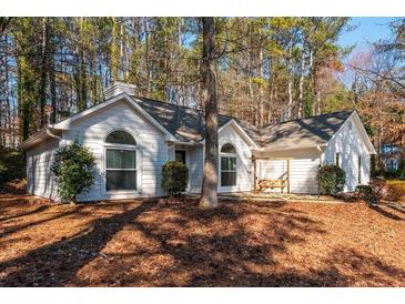 Charming single-story home featuring a neatly maintained lawn and a welcoming front porch swing at 6060 Carriage Dr, Cumming, GA 30028