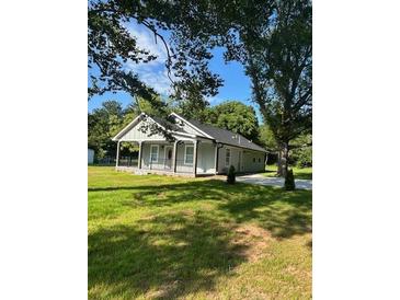 Charming single-story home with a covered front porch and well-maintained lawn at 4321 Austell Powder Springs Sw Rd, Powder Springs, GA 30127