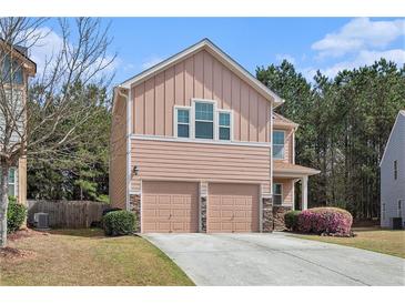 Charming two-story home with a well-manicured lawn and a two-car garage at 2240 Arnold Mill Nw Rd, Lawrenceville, GA 30044