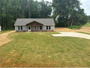 New construction home featuring a freshly installed lawn and a charming covered porch at 482 West Ave, Bowdon, GA 30108
