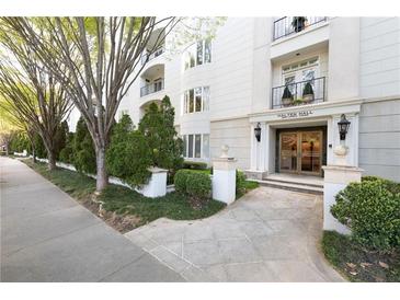 Elegant condo building with manicured landscaping, stone entrance, and classic architectural details at , Atlanta, GA 30305