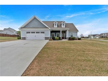Charming one-story home with a two-car garage and a well-manicured lawn at 95 Summerlyn Dr, Hiram, GA 30141