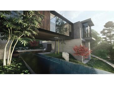 Stunning modern home with a unique architectural design and a tranquil reflecting pool surrounded by lush greenery at 2413 Spalding Dr, Atlanta, GA 30350