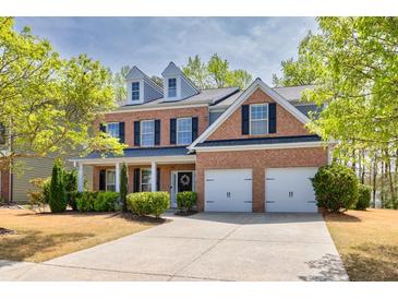Charming two-story brick home with a well-manicured lawn and a two-car garage at 3285 Pebble Ridge Ln, Buford, GA 30519