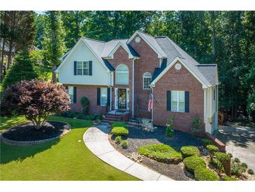 Beautiful two-story brick home with a well-manicured front yard and inviting walkway at 1107 Fieldstone Dr, Canton, GA 30114