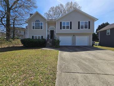 Traditional two-story home with a well-maintained lawn and a two-car garage at 5922 Graywood Cir, Mableton, GA 30126