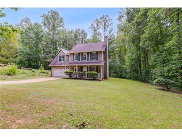 Charming home featuring a lush green lawn and a welcoming front porch perfect for relaxing outdoors at 4558 Dorsett Shoals Ct, Douglasville, GA 30135