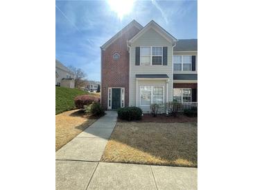 Charming two-story townhome with brick and siding, featuring a well-manicured lawn and inviting entryway at 2742 Snapfinger Manor, Decatur, GA 30035