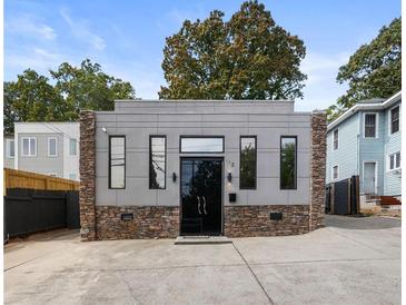 Modern home featuring gray siding, stone accents, and black framed windows at 175 Moreland Se Ave, Atlanta, GA 30316
